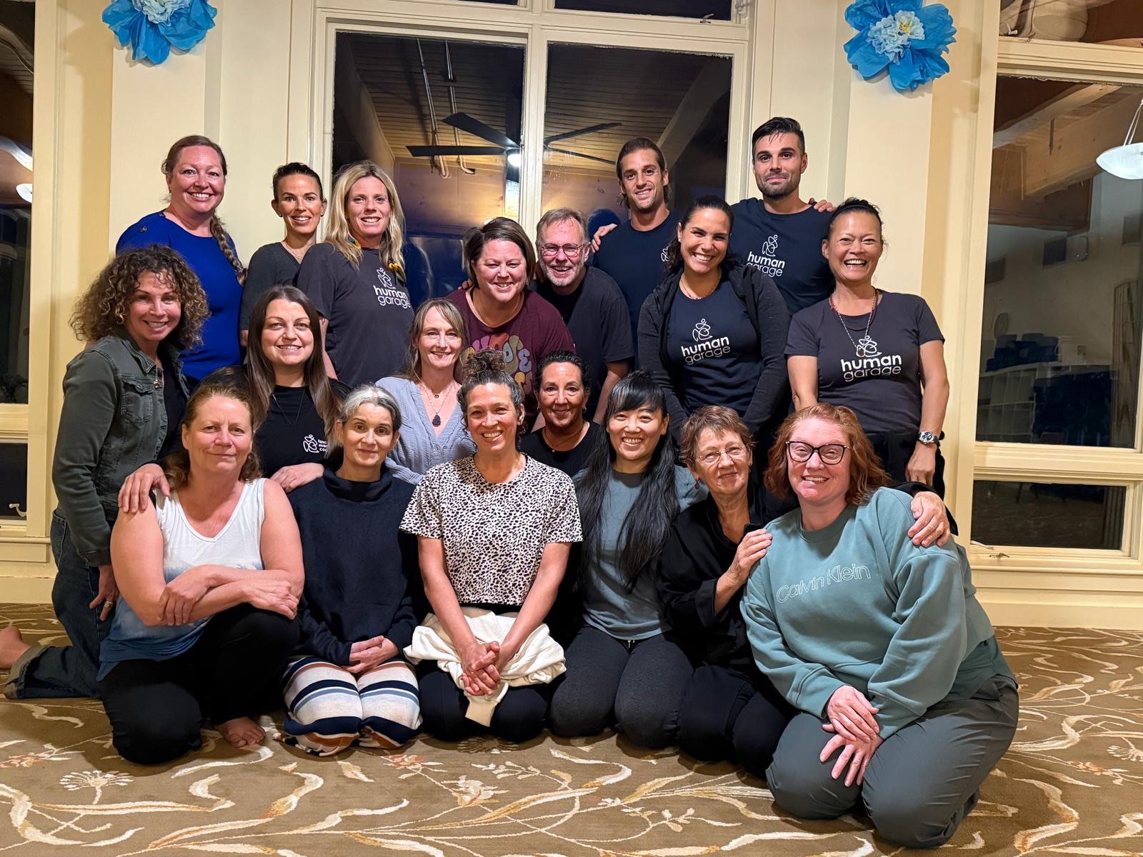 Around twenty Fascial Maneuvers Coaches gathered for a group photograph at the Art of Living Retreat Center.